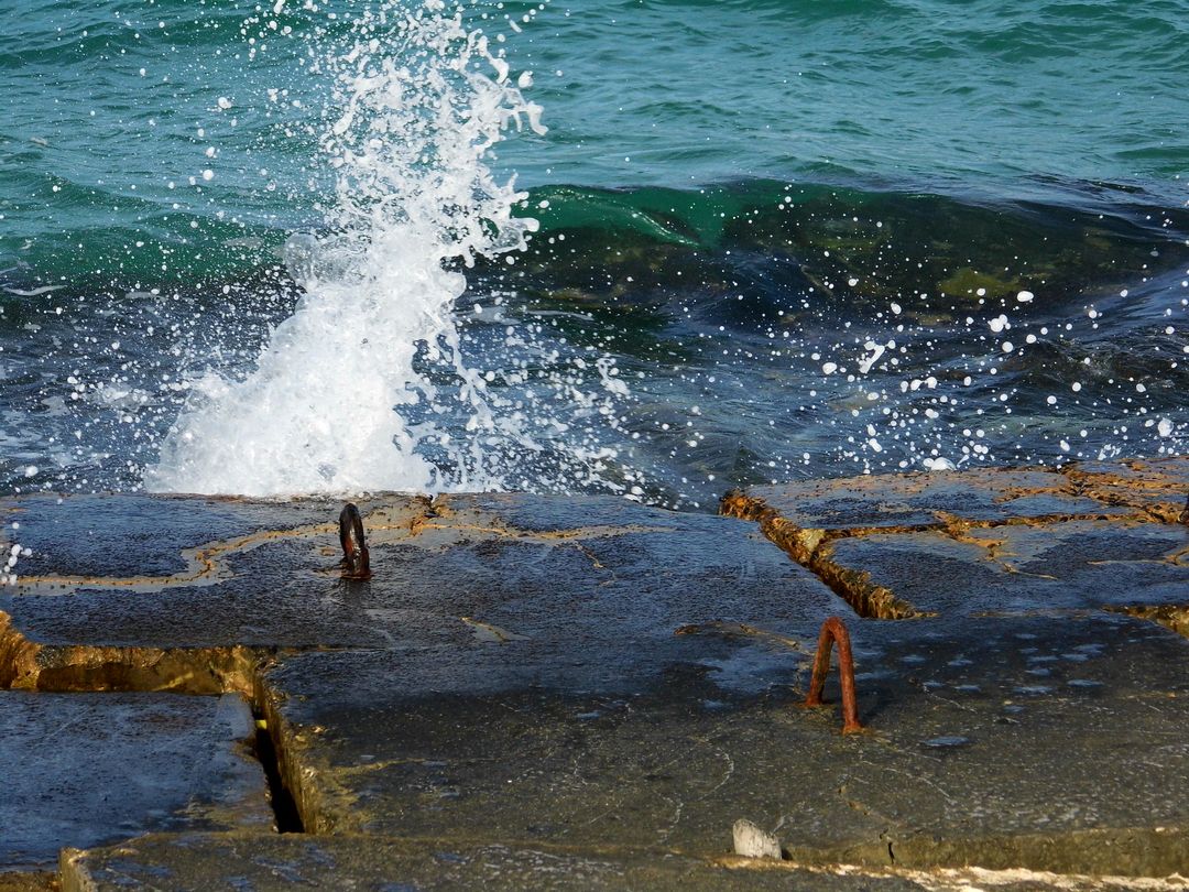 Ocean Waves Crashing on Pier with Rusty Metal Hooks - Free Images, Stock Photos and Pictures on Pikwizard.com