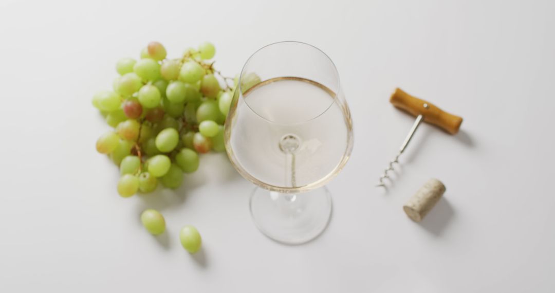 Close-up of White Wine Glass, Grapes, Corkscrew and Cork on White Background - Free Images, Stock Photos and Pictures on Pikwizard.com