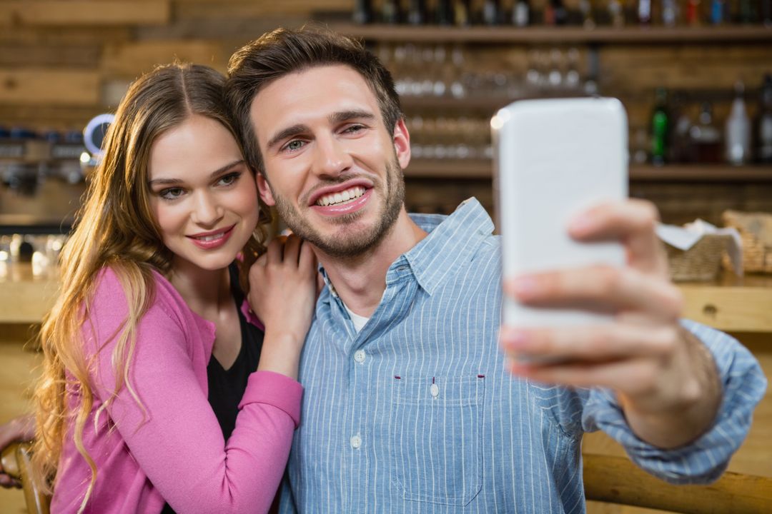 Young couple taking selfie on mobile phone - Free Images, Stock Photos and Pictures on Pikwizard.com