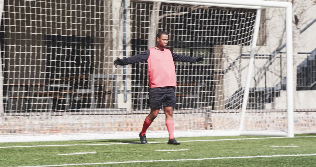 Confident Goalkeeper Standing Guard in Action-Packed Soccer Game