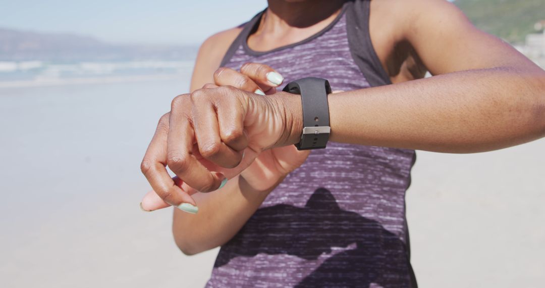 Woman Checking Smartwatch on Beach - Free Images, Stock Photos and Pictures on Pikwizard.com