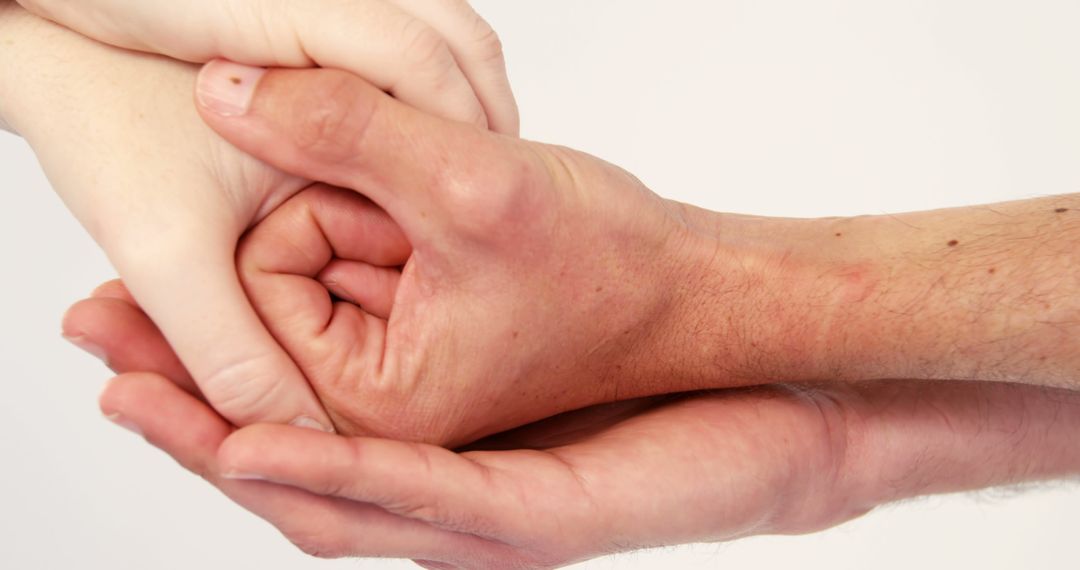 Close-up of couple holding hands against white background - Free Images, Stock Photos and Pictures on Pikwizard.com