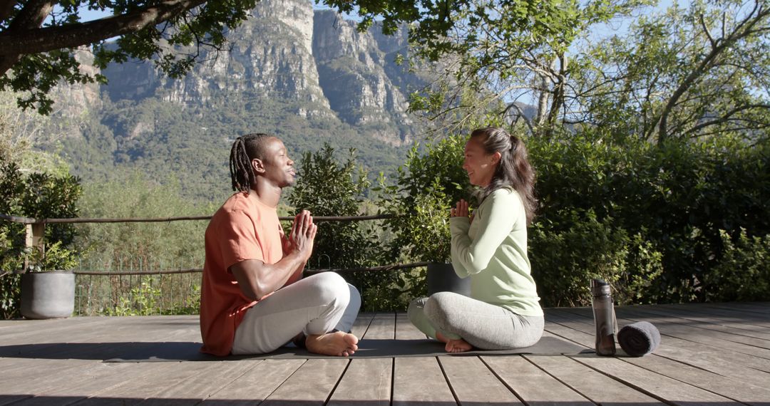 Two People Practicing Yoga Outdoors in Mountainous Setting - Free Images, Stock Photos and Pictures on Pikwizard.com