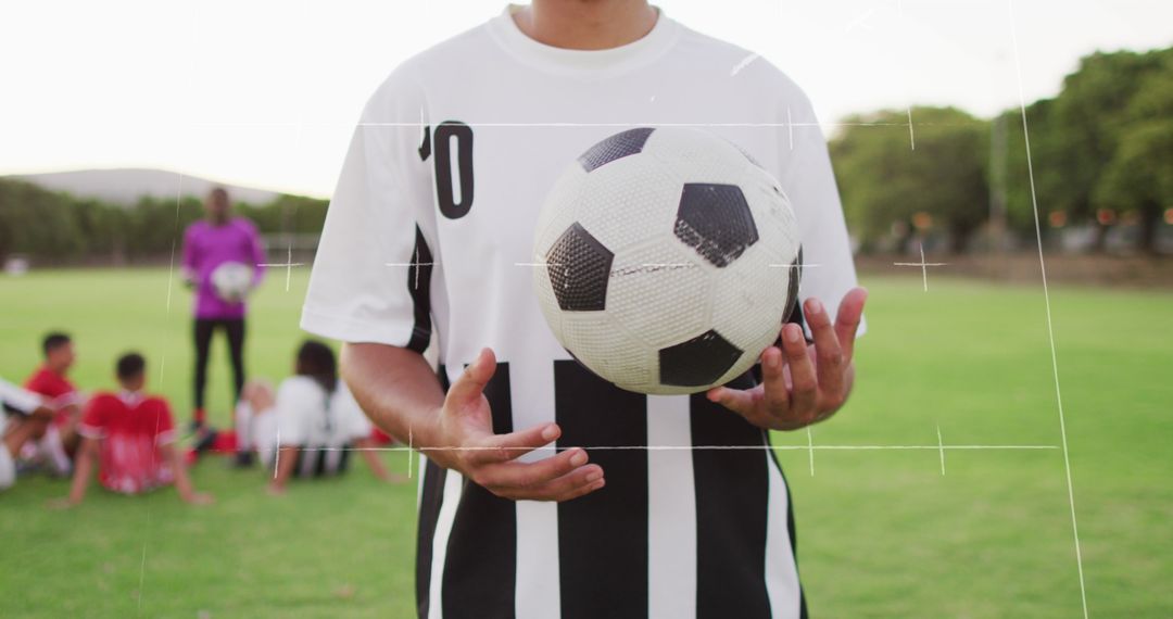 Close-up of Soccer Player with Ball on Field