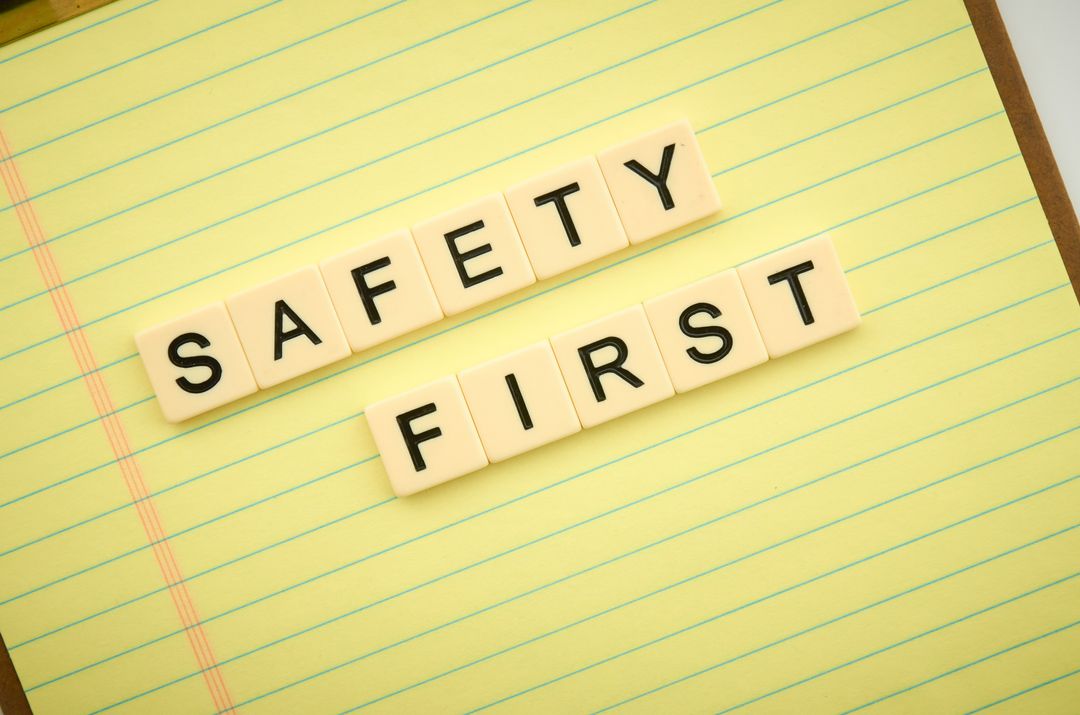 Safety First Concept with Letter Tiles on Notebook Paper