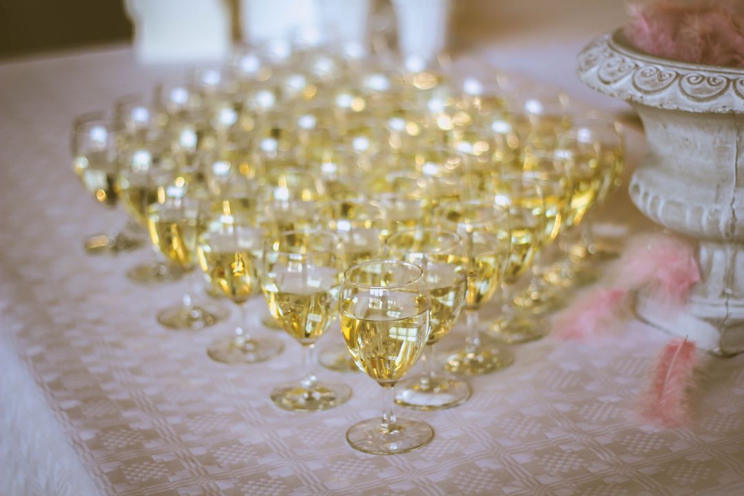 Rows of White Wine Glasses Lining Buffet Table for Elegant Wedding Reception