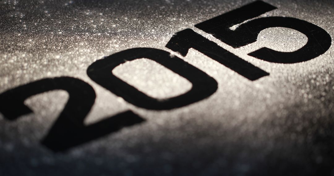 Close-up of 2015 in Bold Black on Glittery Silver Background - Free Images, Stock Photos and Pictures on Pikwizard.com