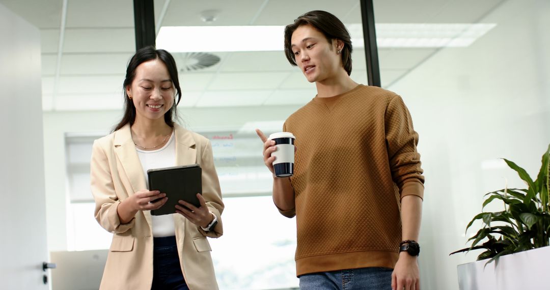 Coworkers Sharing Ideas in Modern Office Environment