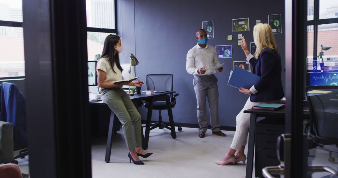 Diverse Team Collaborating Safely in Modern Office Environment