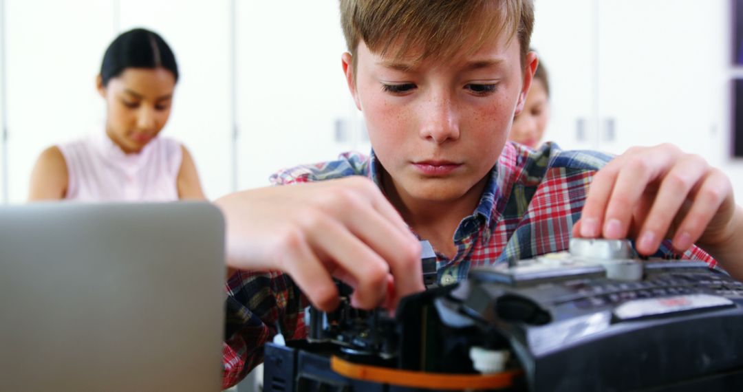 Curious Boy Working on Tech Project in Classroom - Free Images, Stock Photos and Pictures on Pikwizard.com