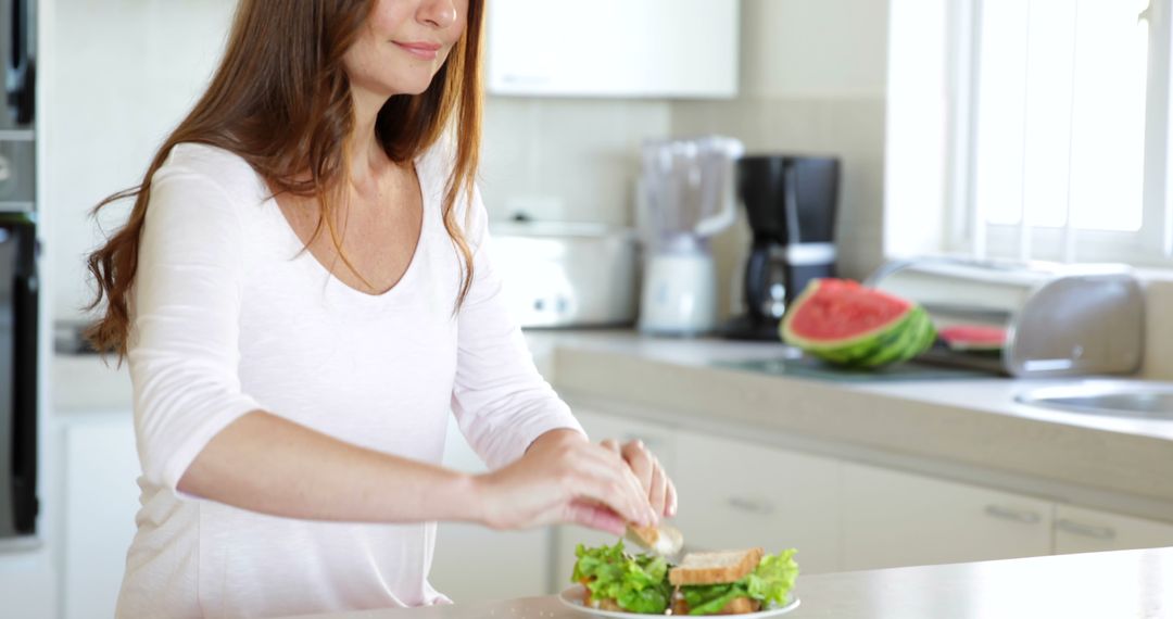 Woman Preparing Healthy Sandwich in Modern Kitchen - Free Images, Stock Photos and Pictures on Pikwizard.com