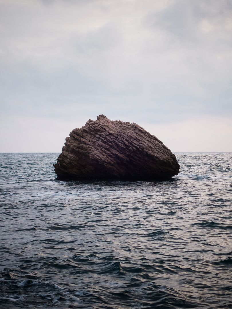 Large Rock Formation in Ocean Amidst Tranquil Waters - Free Images, Stock Photos and Pictures on Pikwizard.com