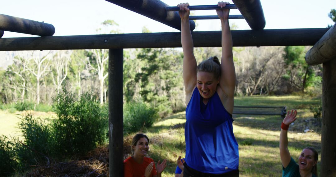 Woman Conquering Monkey Bars at Outdoor Boot Camp - Free Images, Stock Photos and Pictures on Pikwizard.com