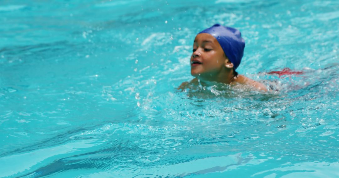 Child Swimming in Pool with Blue Swim Cap - Free Images, Stock Photos and Pictures on Pikwizard.com