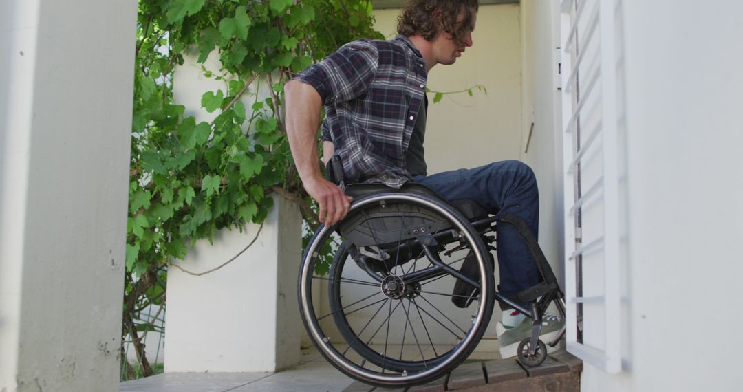 Man in Wheelchair Entering Building Through Accessibility Ramp - Free Images, Stock Photos and Pictures on Pikwizard.com