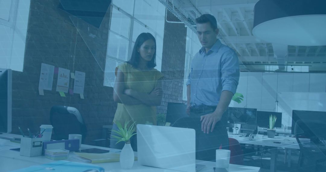 Office Colleagues Collaborating Over Project in Modern Workspace