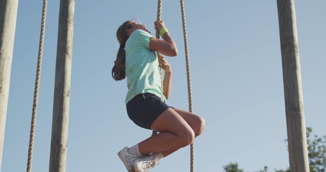 Young Girl Climbing Rope at Outdoor Obstacle Course - Free Images, Stock Photos and Pictures on Pikwizard.com