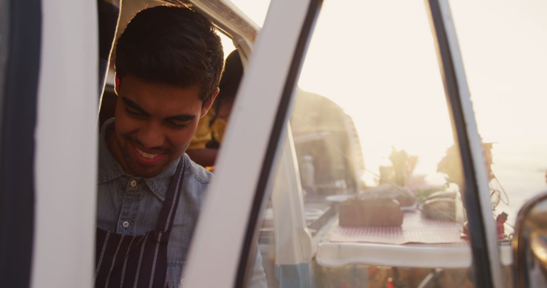 Young Man Working in a Food Truck During Sunset - Free Images, Stock Photos and Pictures on Pikwizard.com