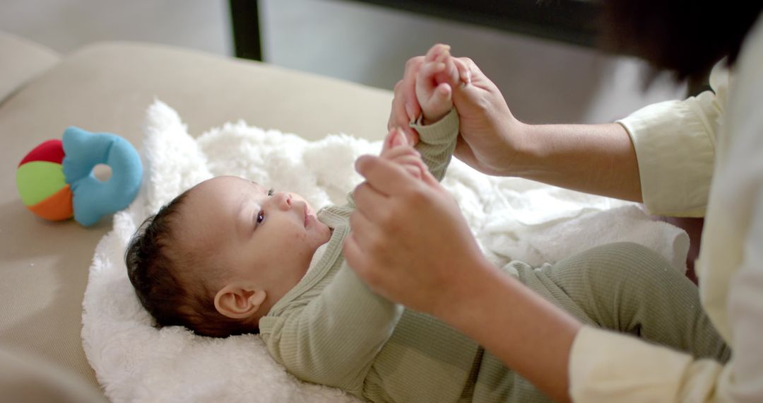 Mother Engaging Baby with Affectionate Interaction on Couch