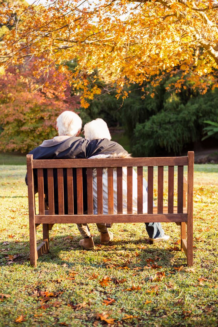 Senior couple embracing on a bench - Free Images, Stock Photos and Pictures on Pikwizard.com