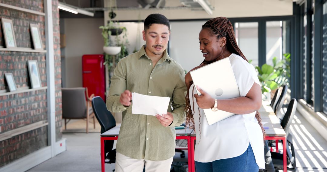 Colleagues Collaborating on Project in Stylish Office Interior