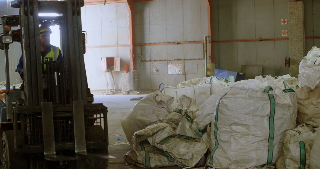 Forklift Operator Moving Large Bags in Warehouse Environment - Free Images, Stock Photos and Pictures on Pikwizard.com