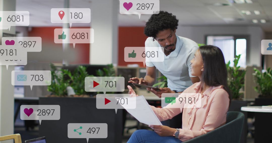 Coworkers Discussing Reports Amid Social Media Notifications