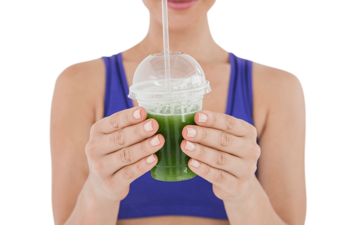 Transparent Cup with Green Juice in Woman's Hands, Health Focused