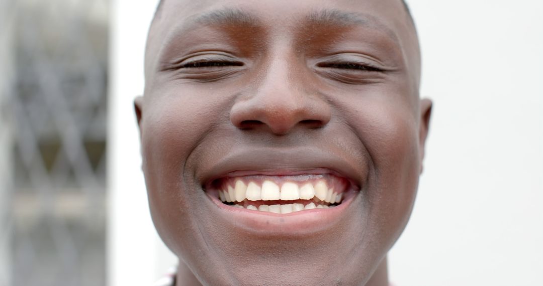 Happy african american man face close up smiling at camera - Free Images, Stock Photos and Pictures on Pikwizard.com