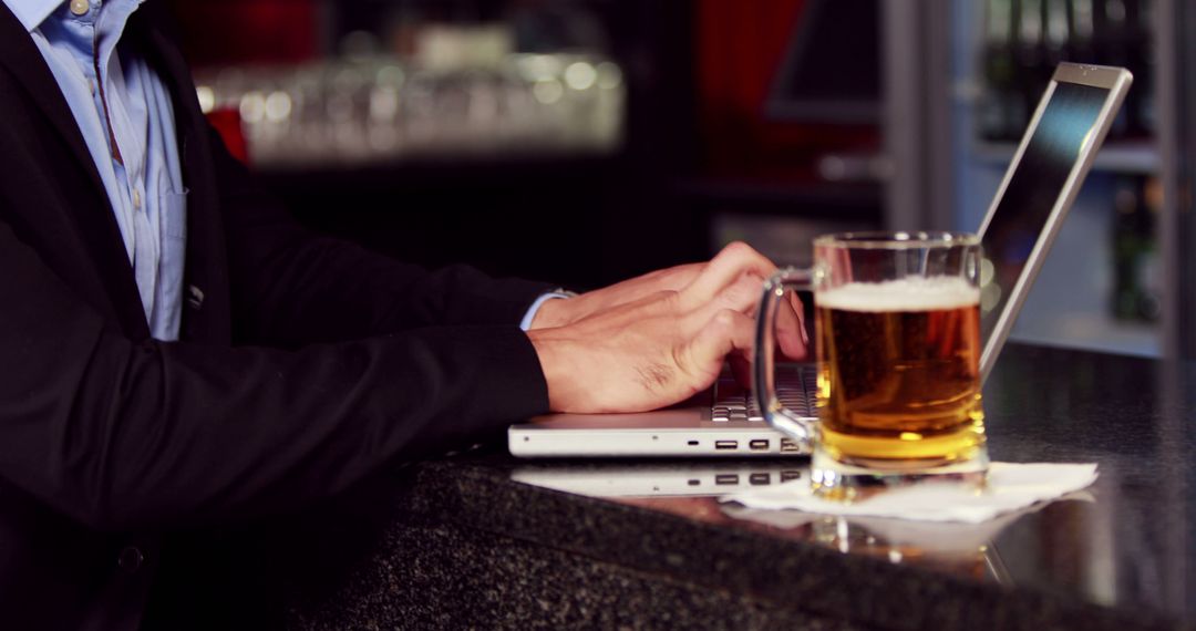 Businessman Balancing Work and Relaxation at Bar