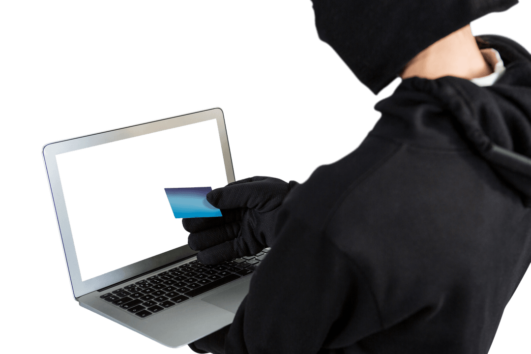 Hacker in Dark Attire Using Laptop and Credit Card