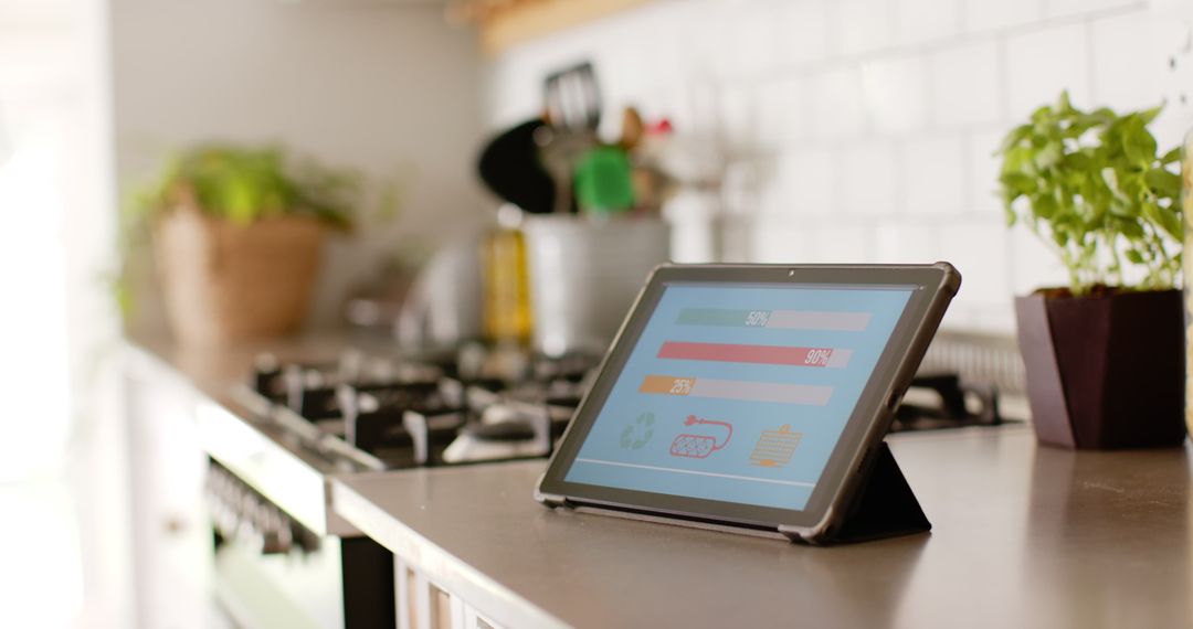 Tablet Displaying Home Energy Usage on Kitchen Counter