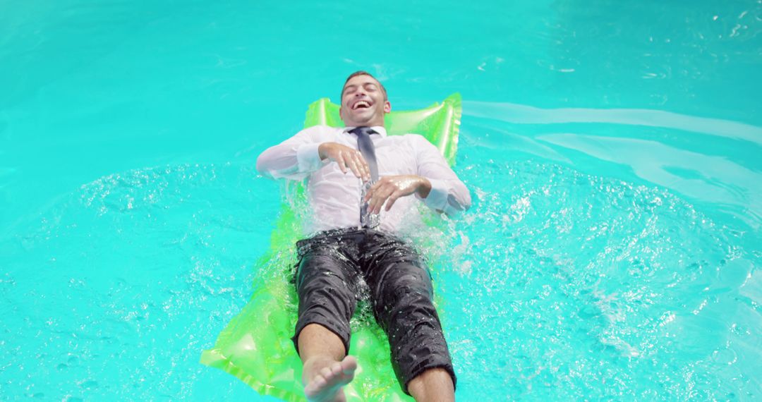 Businessman Enjoying Relaxation on Lilo in Pool - Free Images, Stock Photos and Pictures on Pikwizard.com