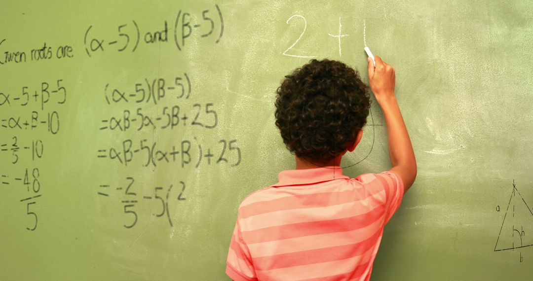 Child Solving Equations on Classroom Chalkboard