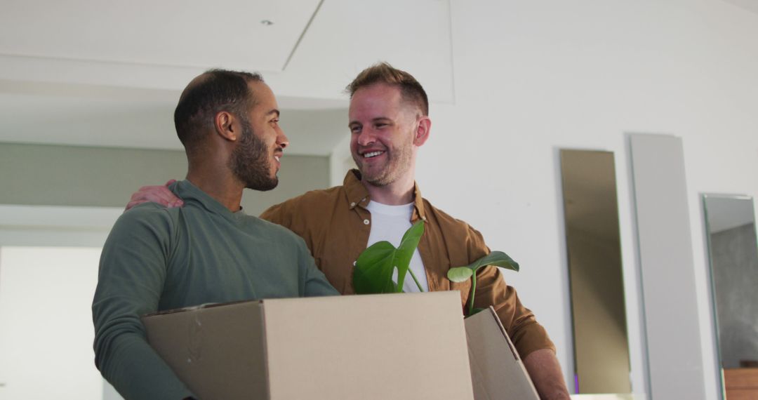 Multi ethnic gay male couple carrying packing boxes into house - Free Images, Stock Photos and Pictures on Pikwizard.com