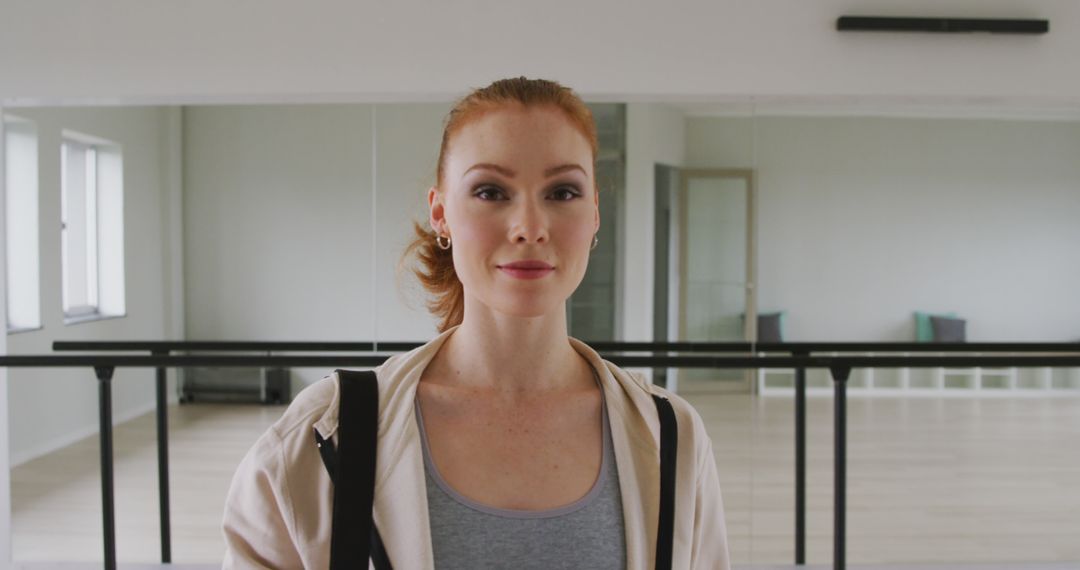 Smiling Female Ballet Dancer in Dance Studio Ready for Training