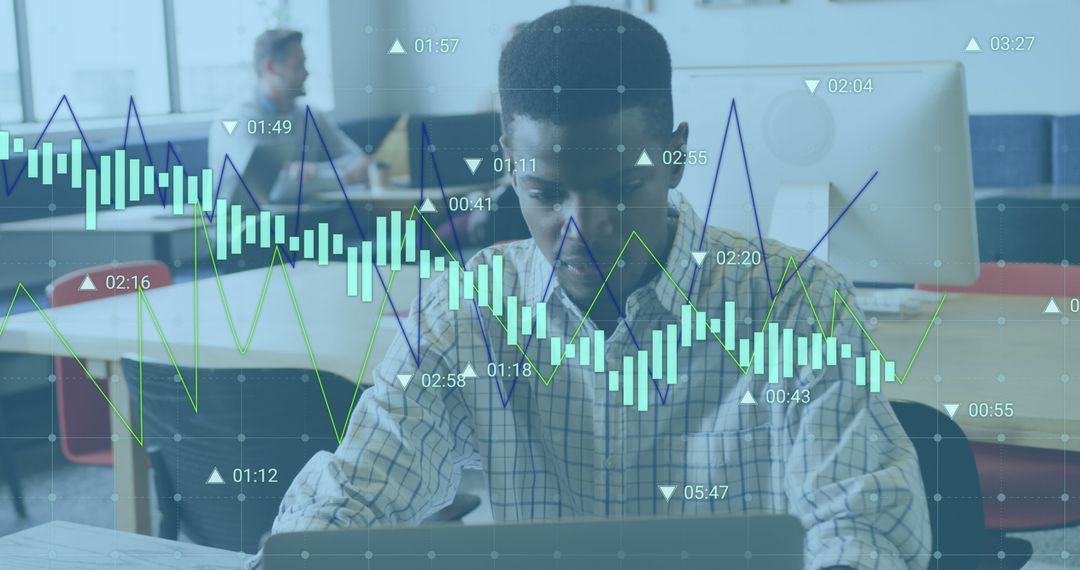 Focused Businessman Analyzing Stock Market Graphs on Laptop in Modern Office - Free Images, Stock Photos and Pictures on Pikwizard.com