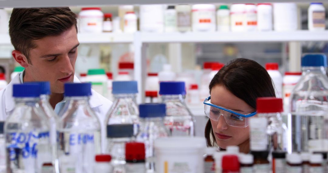 Two Scientists Working in Laboratory with Chemicals - Free Images, Stock Photos and Pictures on Pikwizard.com