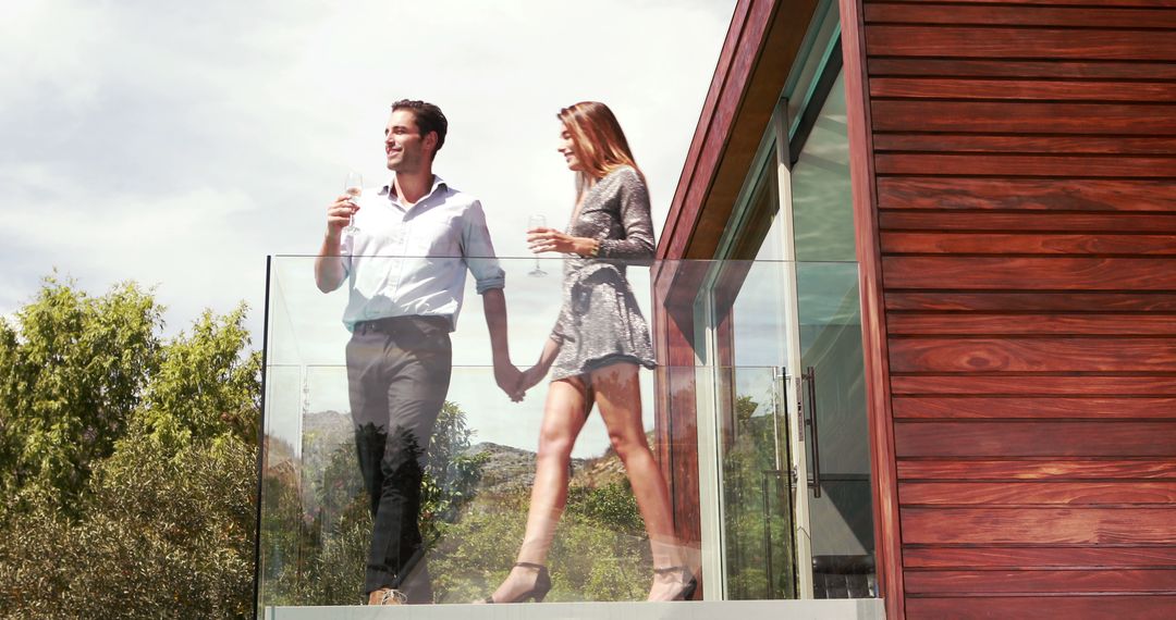 Couple Relaxing on Modern Wooden House Balcony with Drinks - Free Images, Stock Photos and Pictures on Pikwizard.com