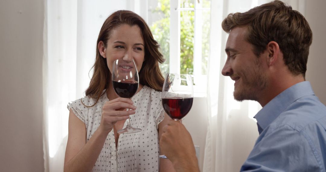 Couple Enjoying Red Wine in Romantic Setting at Home - Free Images, Stock Photos and Pictures on Pikwizard.com