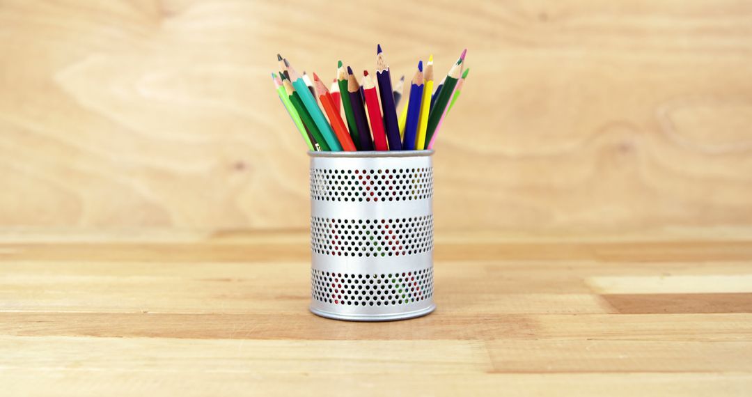 Colorful Pencils in Steel Mesh Holder on Wooden Desk - Free Images, Stock Photos and Pictures on Pikwizard.com