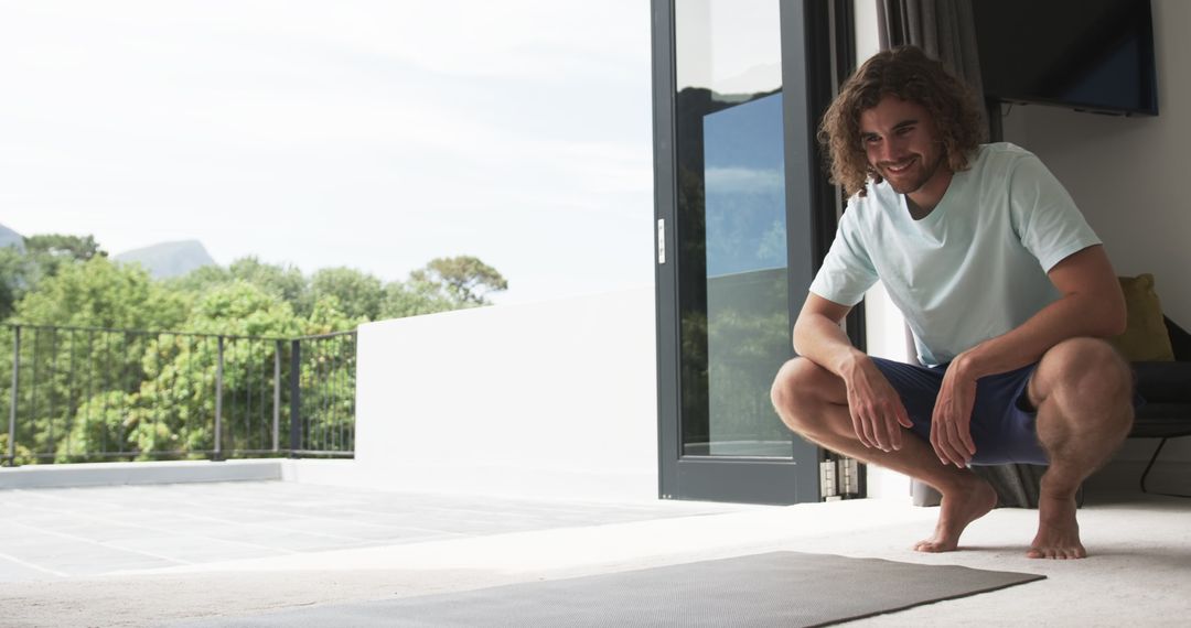 Man Preparing for Home Workout with Yoga Mat, Bright Sunlit Patio View