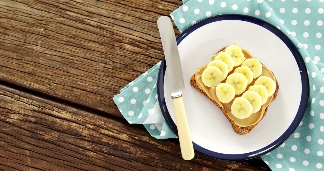 Healthy Toast with Peanut Butter and Banana on Rustic Table