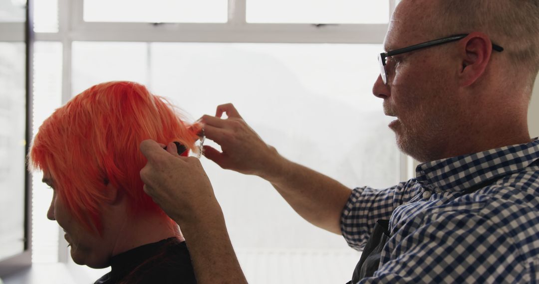 Professional Hairdresser Styling Woman's Vibrant Red Hair in Salon - Free Images, Stock Photos and Pictures on Pikwizard.com