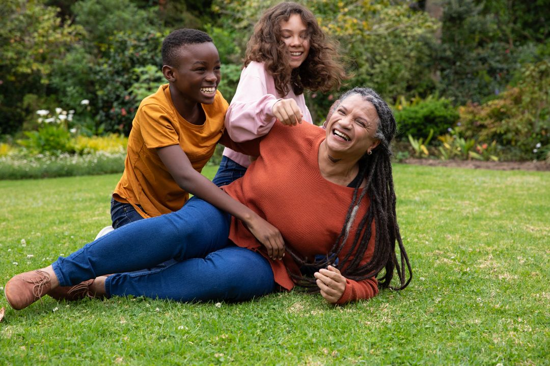 Joyful Family Bonding Time on Green Lawn in Lush Garden Setting