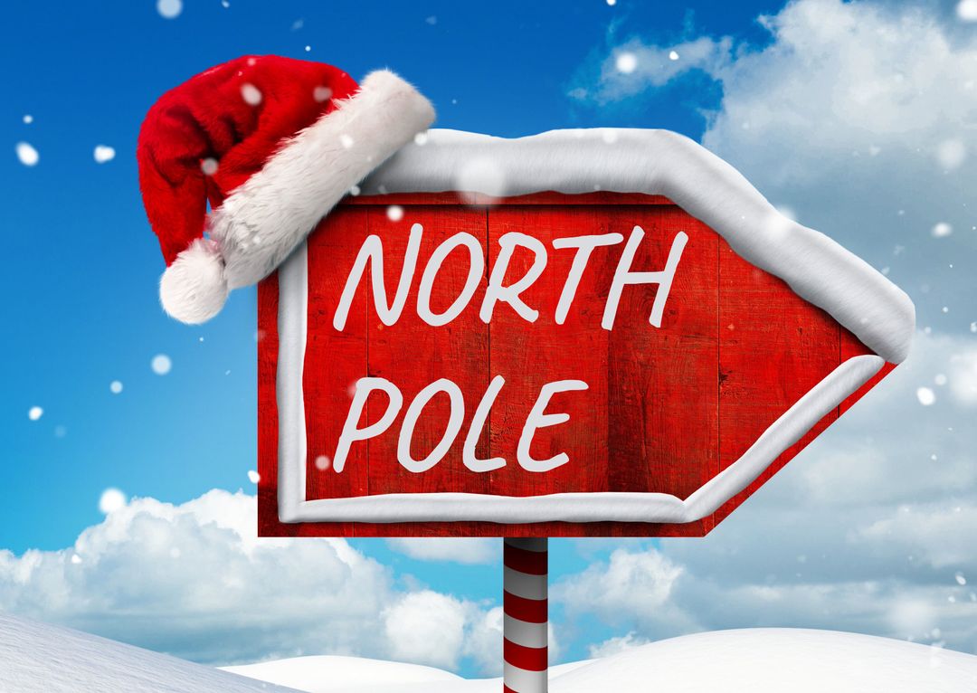 Festive North Pole Sign with Santa Hat in Snowy Landscape