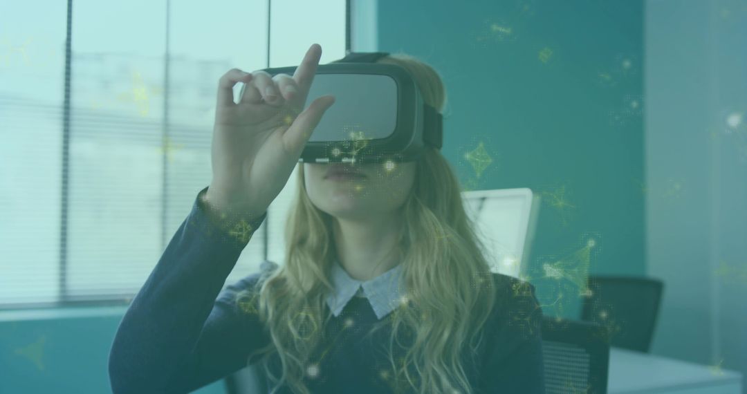 Professional using VR headset in office interacting with holographic AR interface