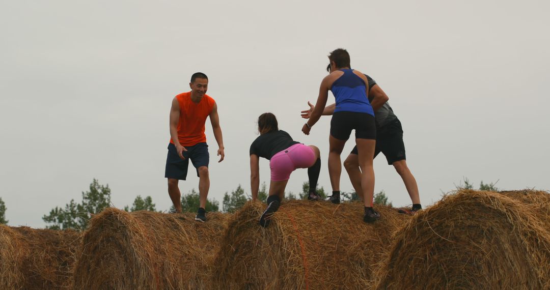 Group of Athletes Climbing Hay Bales During Obstacle Course Race - Free Images, Stock Photos and Pictures on Pikwizard.com