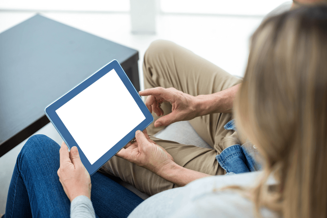Couple Using Transparent Tablet for Relaxation at Home