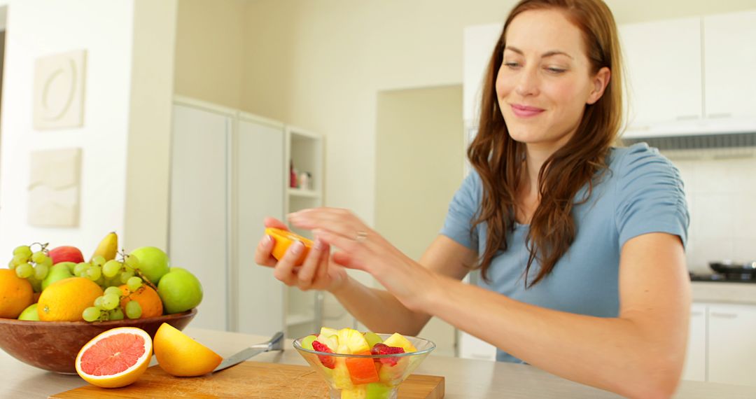 Woman Preparing Fresh Fruit Salad in Modern Kitchen - Free Images, Stock Photos and Pictures on Pikwizard.com